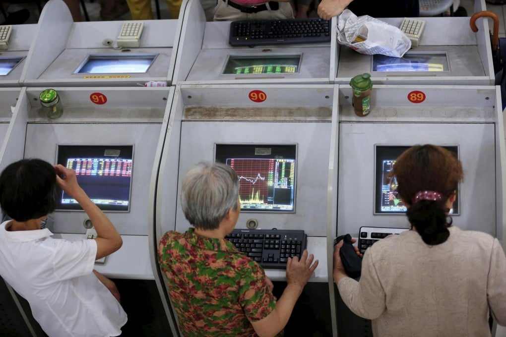 Investors checking the performance of their stocks as the mainland market took another tumble on Monday. Photo: Reuters