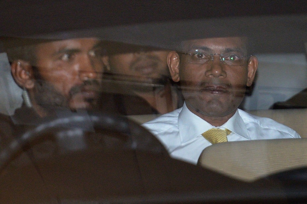 Former Maldives president Mohamed Nasheed (R) sits in vehicle after attending a March hearing on terrorism charges. Photo: AFP