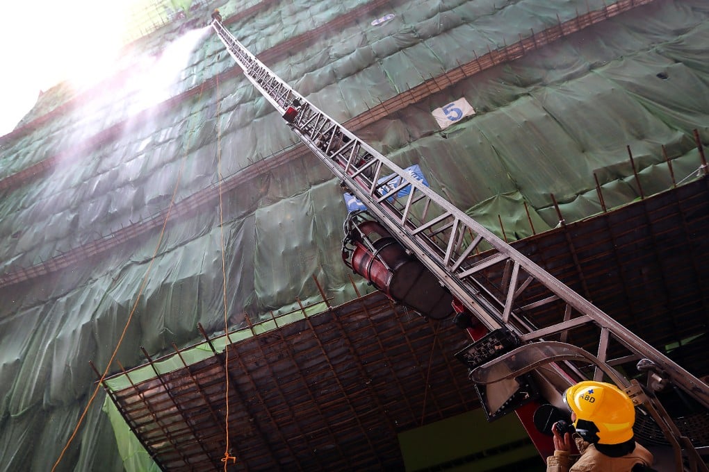 Firefighters try to reach the top of the uncompleted building on Heung Yip Road, Aberdeen. Photos: Sam Tsang
