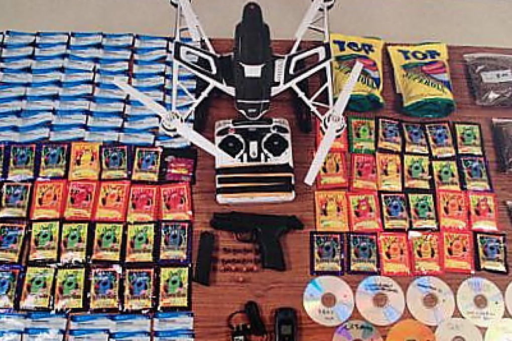 The haul of porn and drugs and the drone that was intended to carry it into prison. The gun was seized from the would-be smugglers, but it is not thought to have been intended as cargo. Photo: Maryland Department of Public Safety and Correctional Services