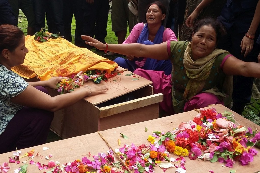 Relatives of a police officer killed in a clash with protesters on Monday mourn over the coffins in Kailali district, Nepal. Photo: Xinhua