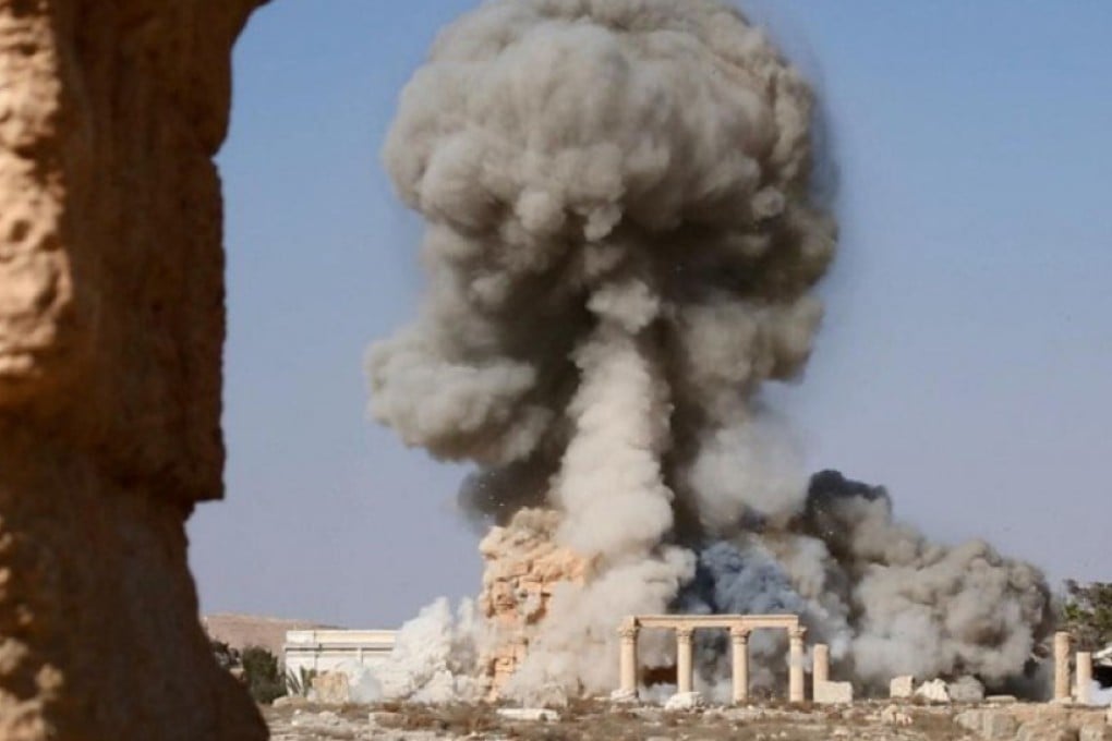 The building believed to the renowned ancient Roman temple Baal Shamin in the Syrian city of Palmyra is blown up by explosives. Photo: Kyodo