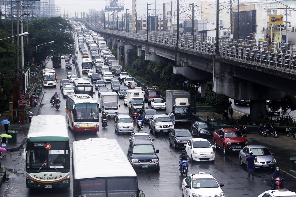 Traffic was heavy - as usual - during a downpour in Quezon city, east of Manila, last Thursday. Photo: EPA