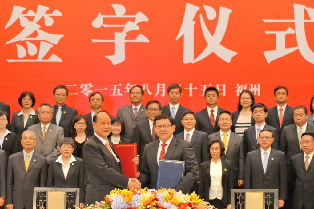 Officials from China mainland and Taiwan exchange texts after they signed two agreements concerning cross-Strait flight safety and taxation cooperation in Fuzhou. Photo: Xinhua