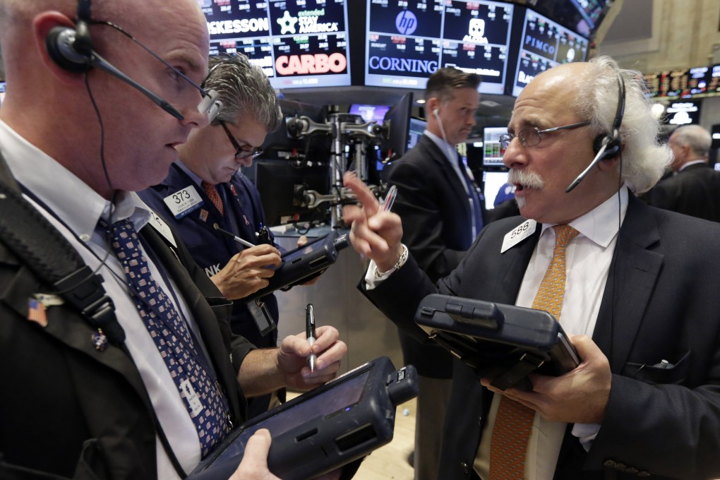 Wall Street traders confer as trading was whip-sawed by further turmoil in China's financial markets. Photo: AP
