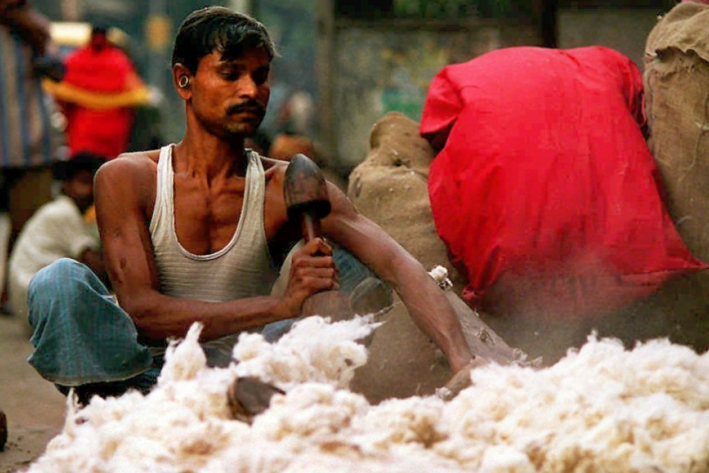 A worker recycles old cotton in the Indian city of Calcutta. Photo: AFP