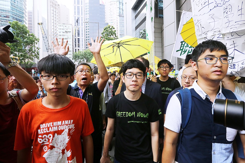 Joshua Wong, Nathan Law and Alex Chow arrive at police headquarters in Wan Chai on Thursday. Photo: Sam Tsang
