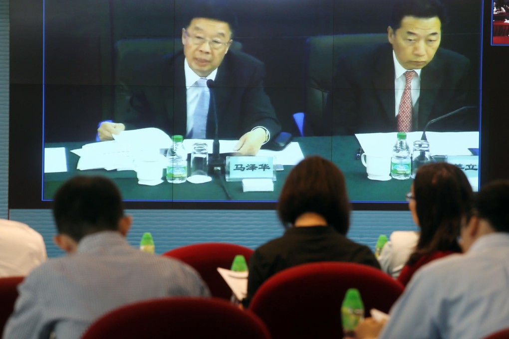 China Cosco's Ma Zehua (left) and Jiang Lijun face the press in a video conference on the company's results. Photo: Dickson Lee