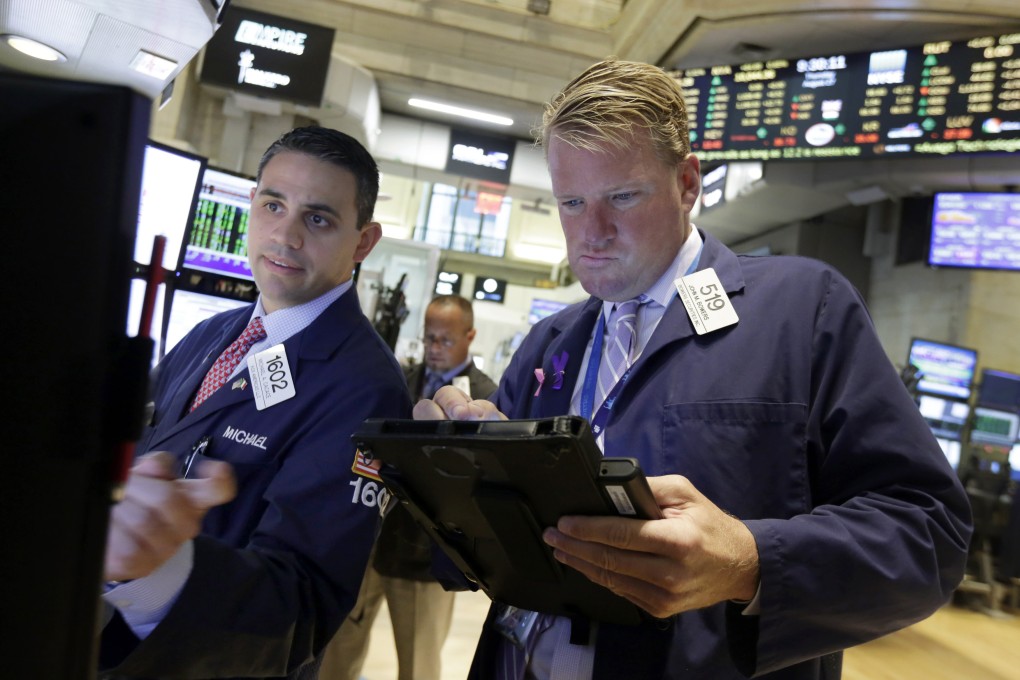Traders work the floor of the New York Stock Exchange as Wall Street and global stocks rally for the second day as fears over slowing China growth receded for now. Photo: AP