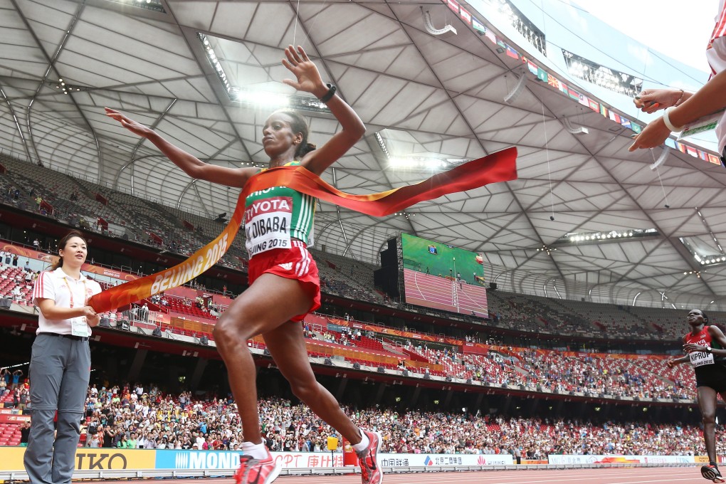Mare Dibaba breaks the tape in the Bird's Nest. Photo: EPA