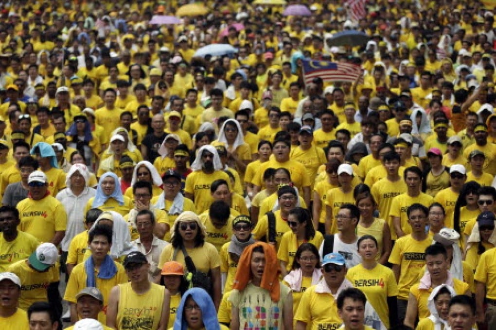 Malaysian protesters singing their protest song during a BERSIH (The Coalition for Free and Fair Elections) rally in Kuala Lumpur today. Photo: EPA