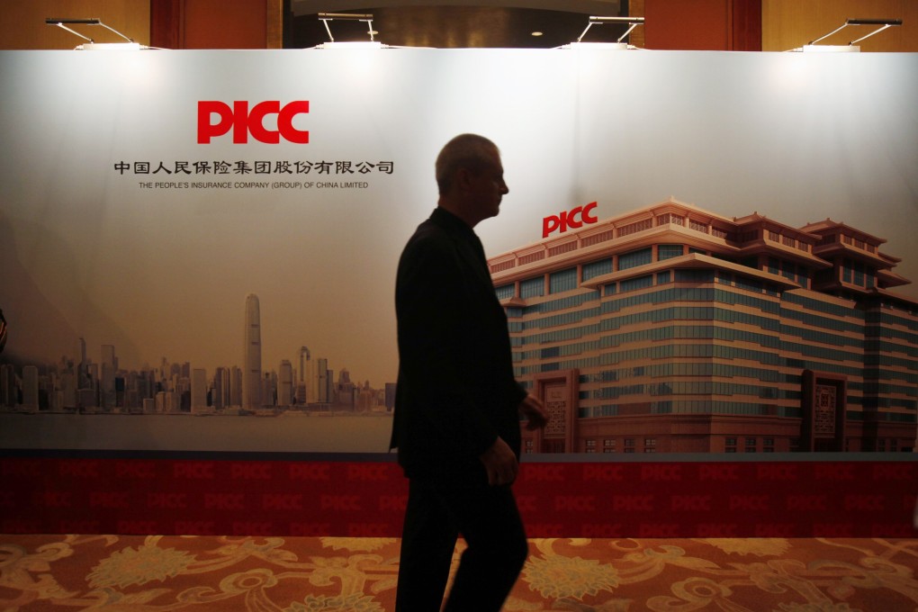 A man walks past the signboard of PICC, which is planning to set up an internet finance arm as soon as this year. Photo: Reuters