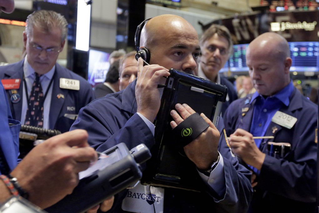 Traders scramble on the floor of the New York Stock Exchange last Friday after global equities finished quietly after a turbulent week. Photo: AP
