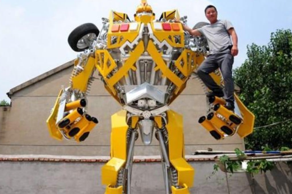 Welder Wang Liansheng poses with his version of the Transformer's character Bumblebee Autobot that he built for his in their backyard. Photo: ThePaper.cn