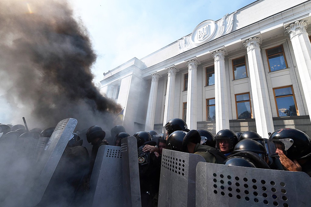 Smoke rises from the parliament building in Kiev as activists of radical Ukrainian parties clash with police. Photo: AFP