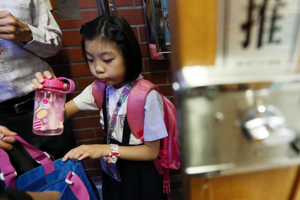 Parents accompany their child to school in Wan Chai. Photo: Nora Tam