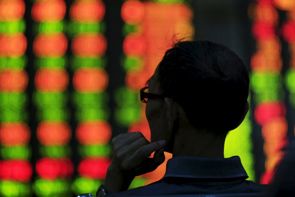 A Chinese investor peers at stock prices in Shanghai as weak manufacturing data knocked prices lower in the country's equity markets. Photo: Reuters