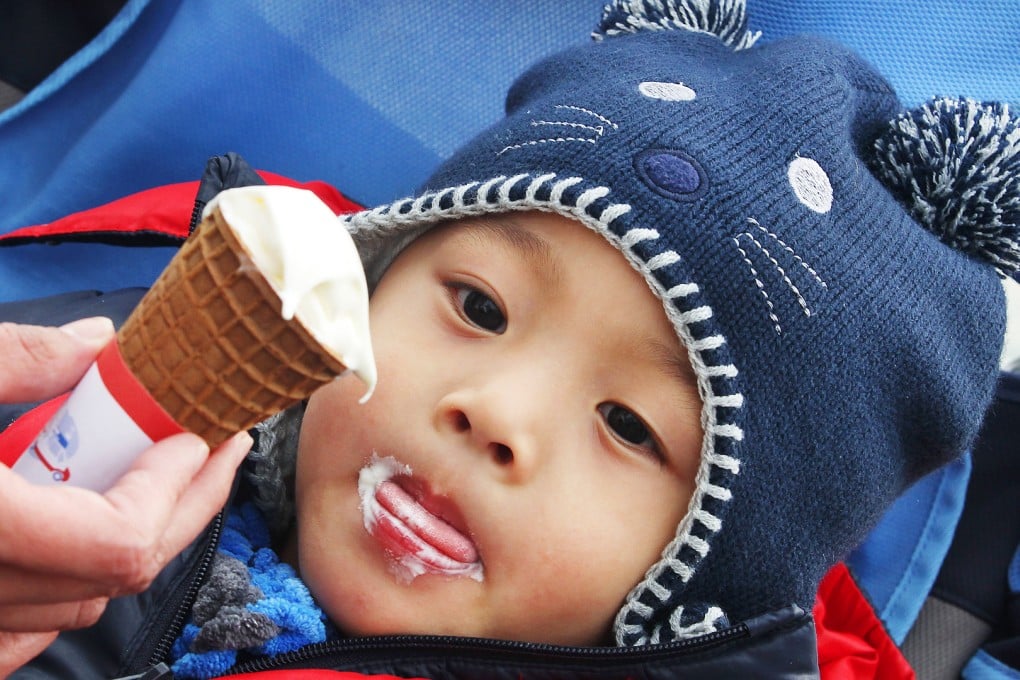 A youngster enjoys an ice cream cone at Star Ferry Pier in Tsim Sha Tsui.  Photo: Nora Tam