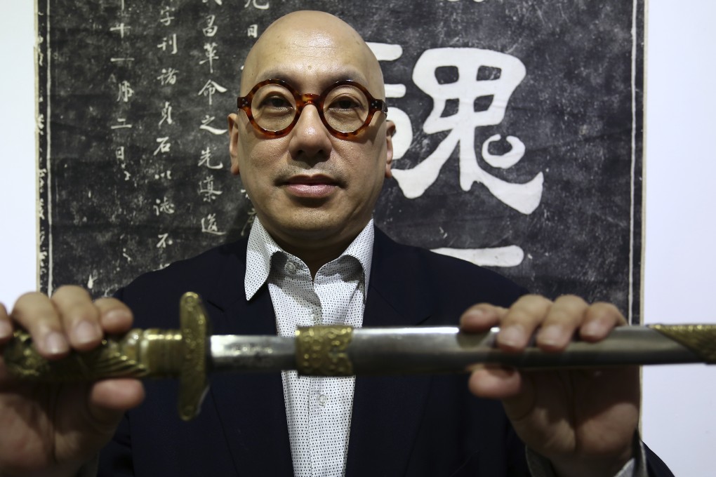 Soong Shu-kong holds an air force dagger with engraving, one of the artefacts at the exhibition. Photo: Jonathan Wong