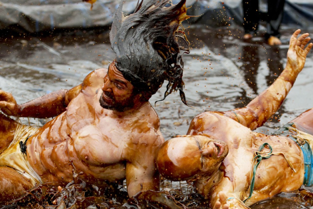 Competitors slug it out in the gravy pool at the Rose’n’Bowl carvery in Stacksteads, Lancashire, on Monday. Photo: AFP