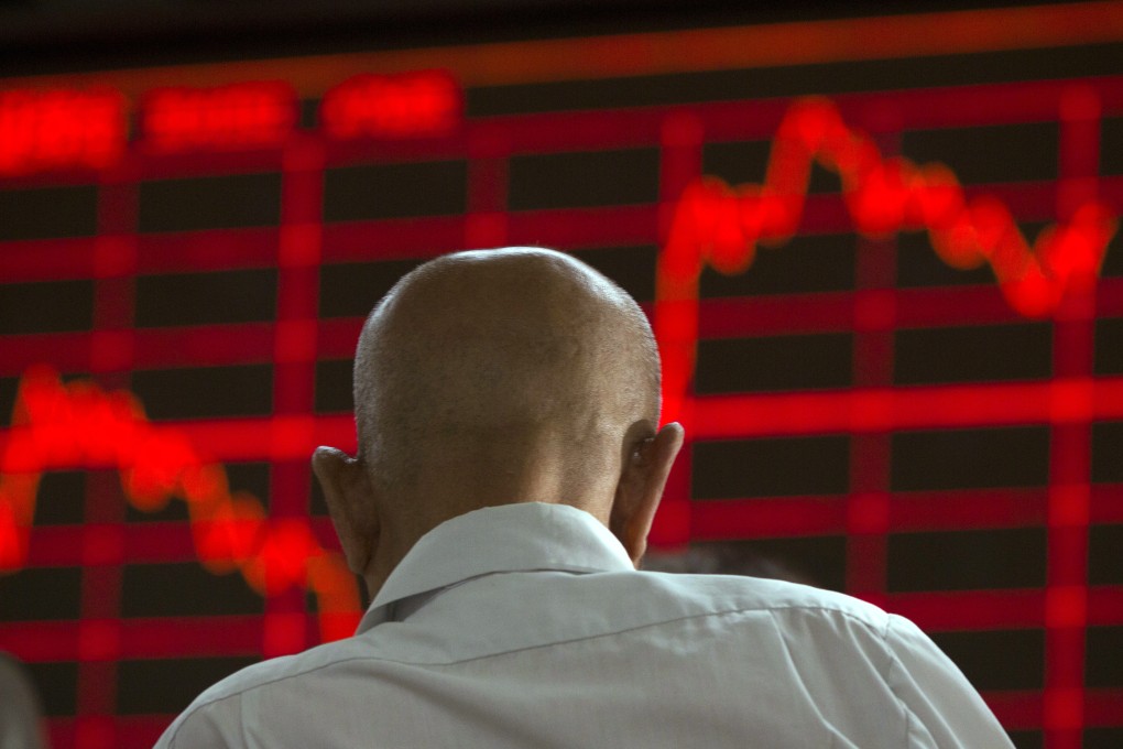 A Chinese investor monitors stock prices at a brokerage in Beijing as poor manufacturing data again pressured equity markets in Shanghai, Shenzhen and Hong Kong. Photo: AP