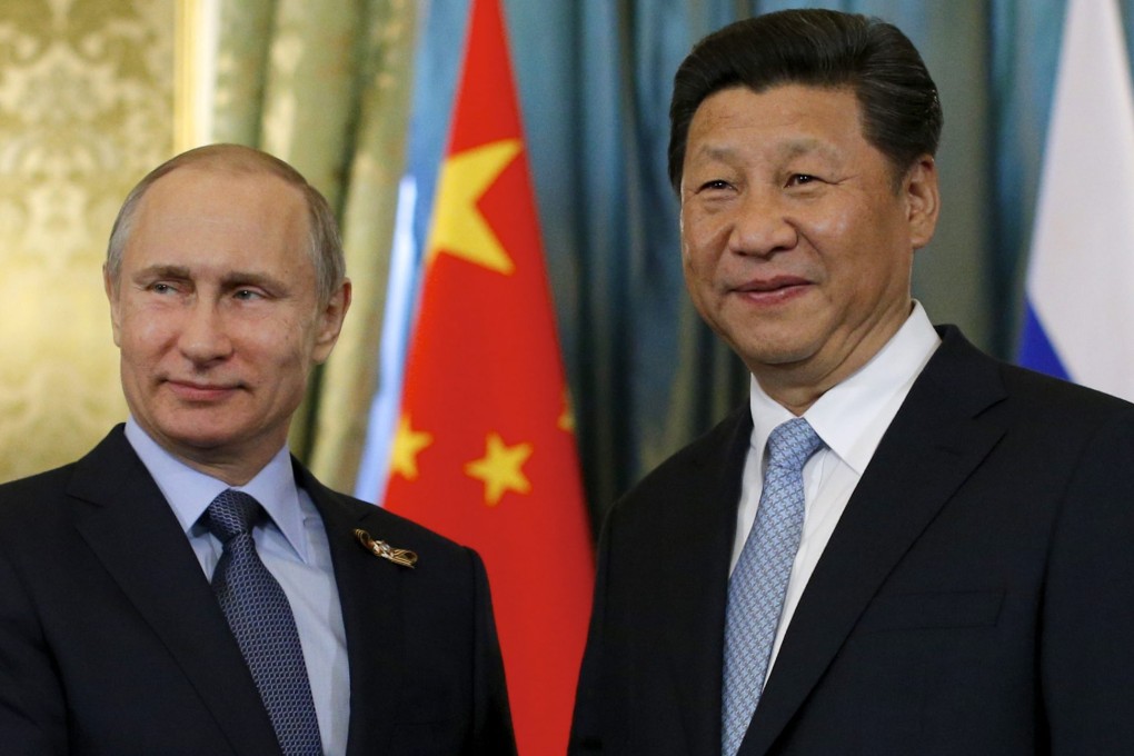 President Vladimir Putin (left) and President Xi Jinping shake hands during a meeting in Moscow in May. Photo: EPA