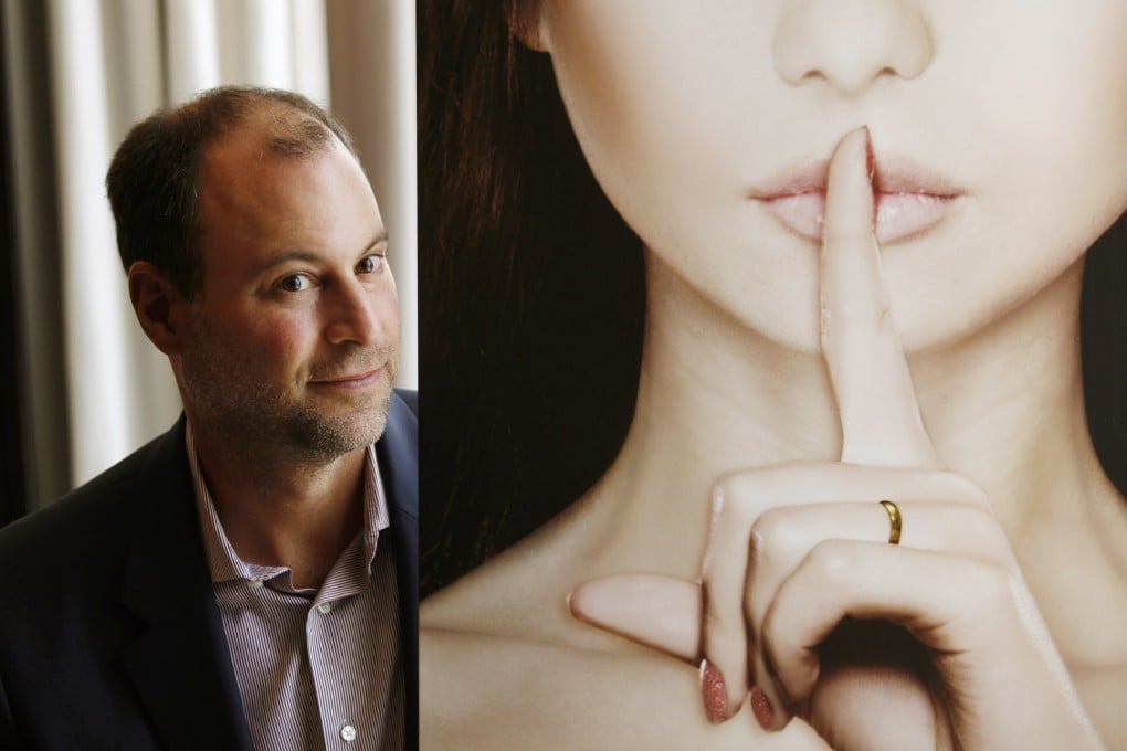 Ashley Madison founder Noel Biderman poses with a poster during an interview at a hotel in Hong Kong a few years ago. Photo: Reuters