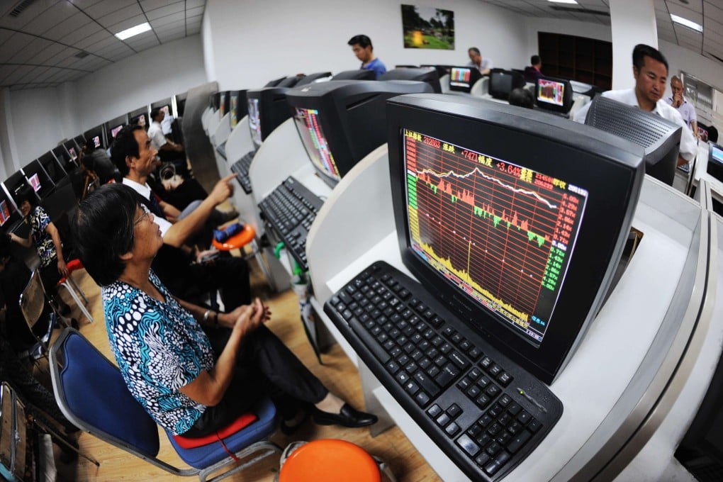 Investors stare at screens at a brokerage house in China as markets in Shanghai and Shenzhen ended a holiday-shortened week with small losses. Photo: Xinhua