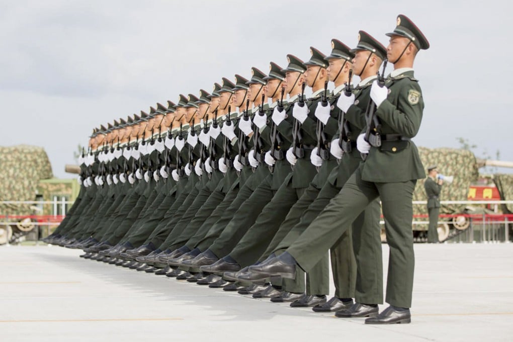 Soldiers of China's People's Liberation Army march with their weapons during a training session for Thursday's parade, at a military base in Beijing. Photo: Reuters