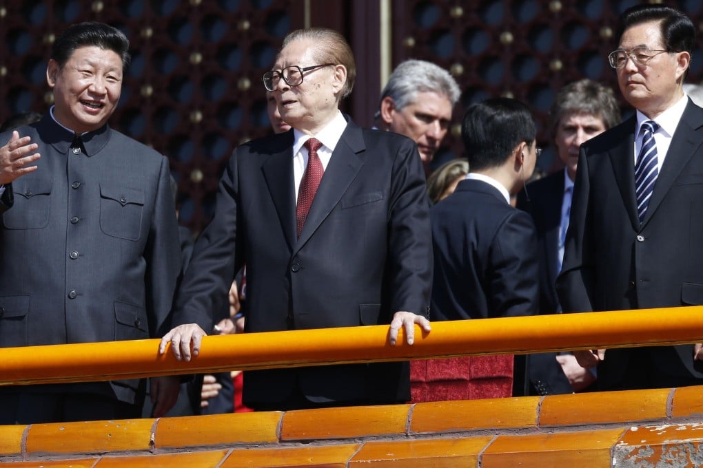 From left: President Xi Jinping talks to former president Jiang Zemin as Hu Jintao, Jiang's successor, looks on at the Tiananmen rostrum during a military parade in Beijing on Thursday. Photo: AFP