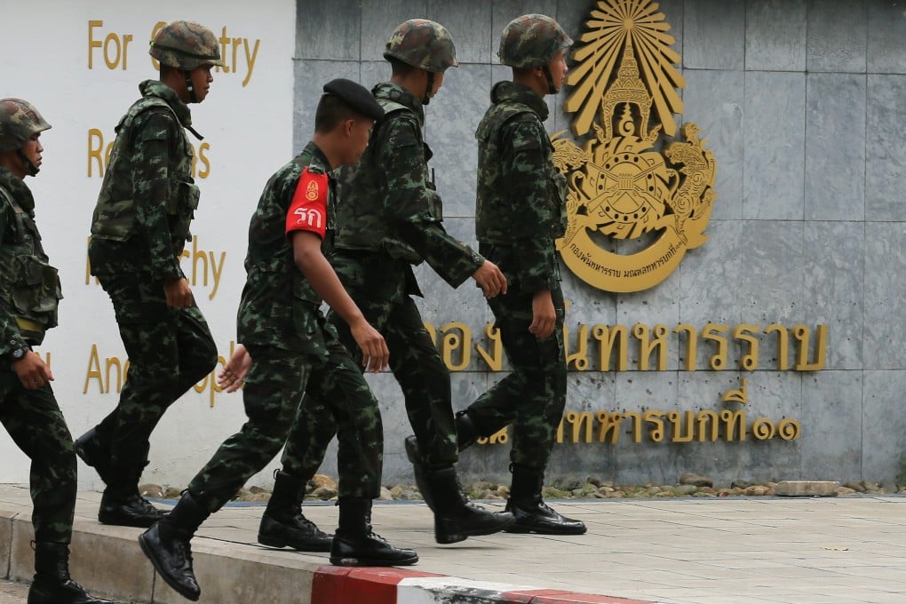 Soldiers walk in front of the military base, in Bangkok, Thailand, where one of the arrested suspects is detained. Photo: EPA