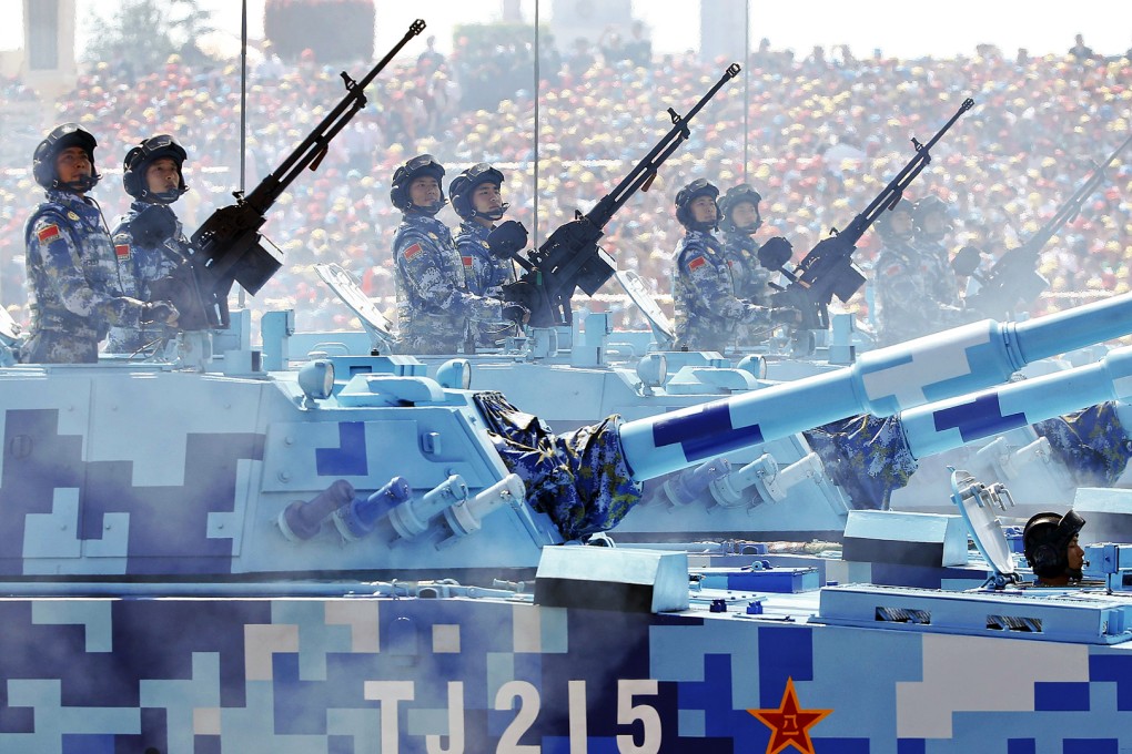 PLA navy soldiers roll on their armoured vehicles to Tiananmen Square during the military parade on Thursday. Photo: Reuters