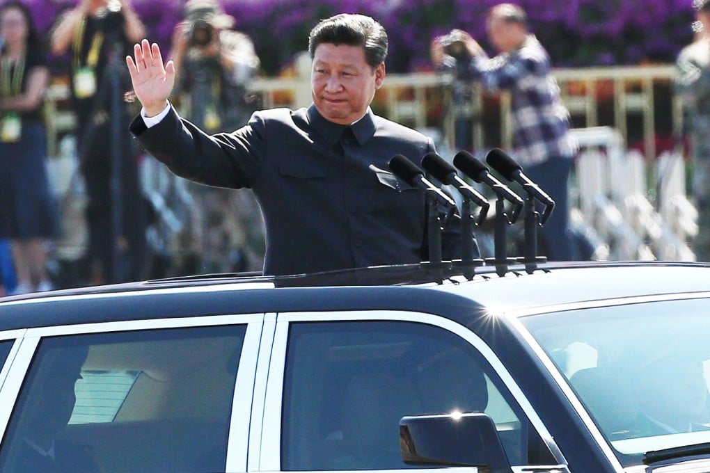 President Xi Jinping waves from a car as he reviews troops on Tiananmen Square during the military parade. Photo: EPA