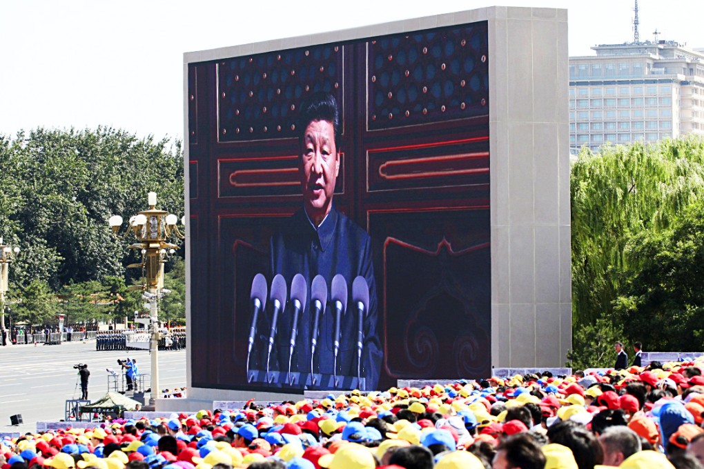 Spectators look on as an electronic screen shows President Xi Jinping delivering a speech at the start of the military parade marking the 70th anniversary of the end of the second world war. Photo: Reuters