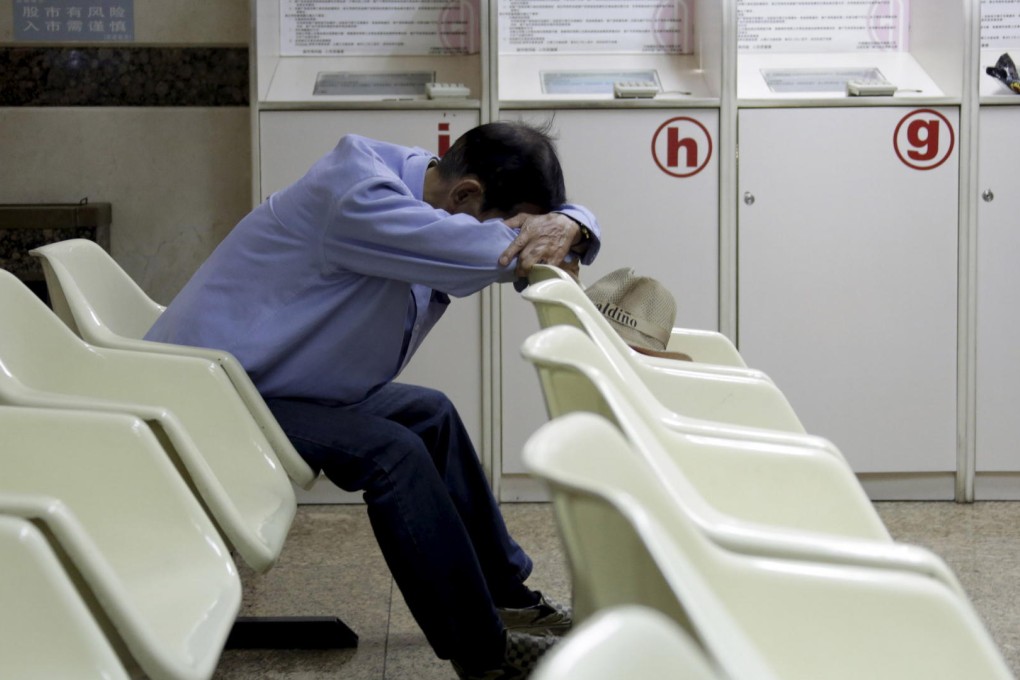 An investor takes a nap at a brokerage. The H-share index is down 6 per cent for the week, having lost 24 per cent so far this year. Photo: Reuters
