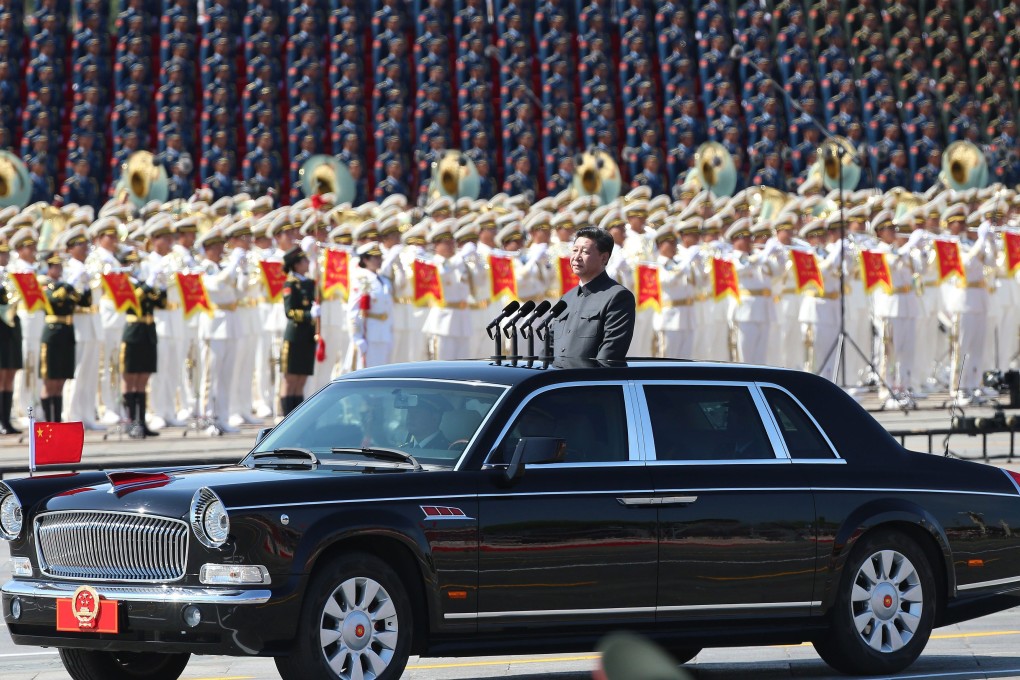 Chinese President Xi Jinping inspects troops in his purpose-made limousine. Photo: EPA
