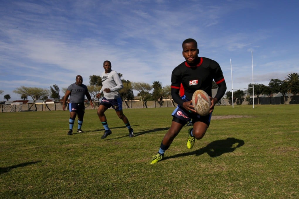 Members of the Young Ideas rugby team warm up before a club match in Langa, Cape Town's oldest black township. Twenty years after former president Nelson Mandela wore a Springboks jersey to promote racial reconciliation, many South Africans are unconvinced the 2015 RWC squad reflects their society. Photo: Reuters