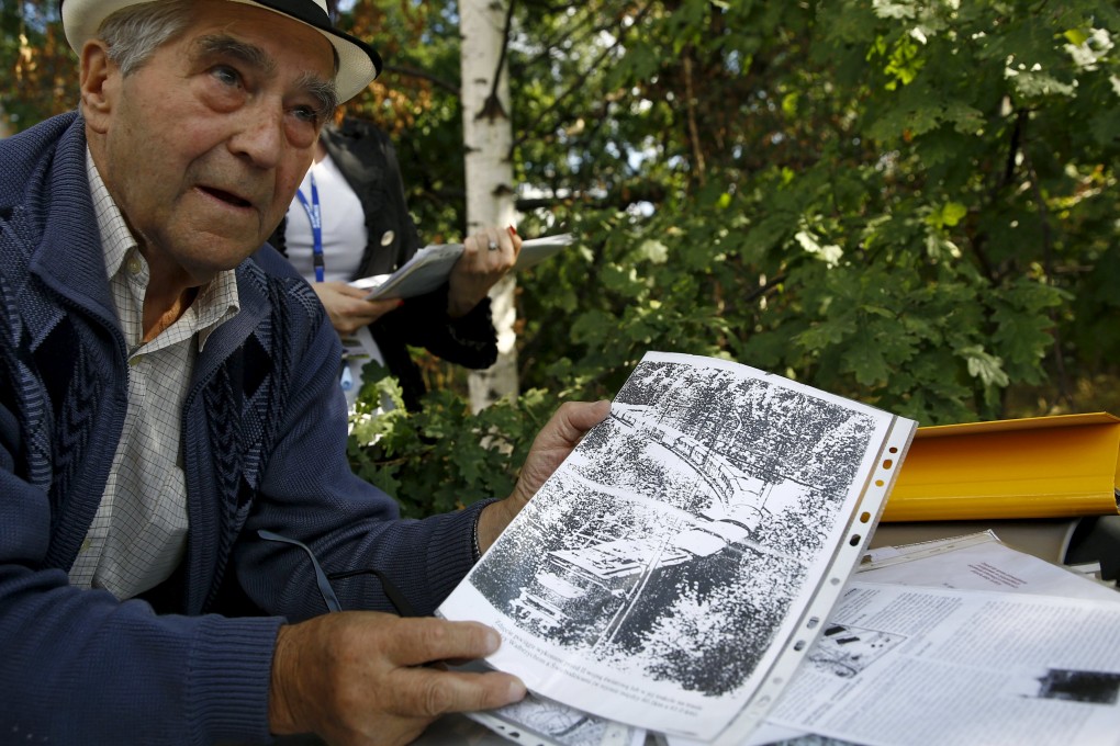 Tadeusz Slowikowski, retired miner and explorer shows documents near the supposed site of the Nazi train. Photo: Reuters