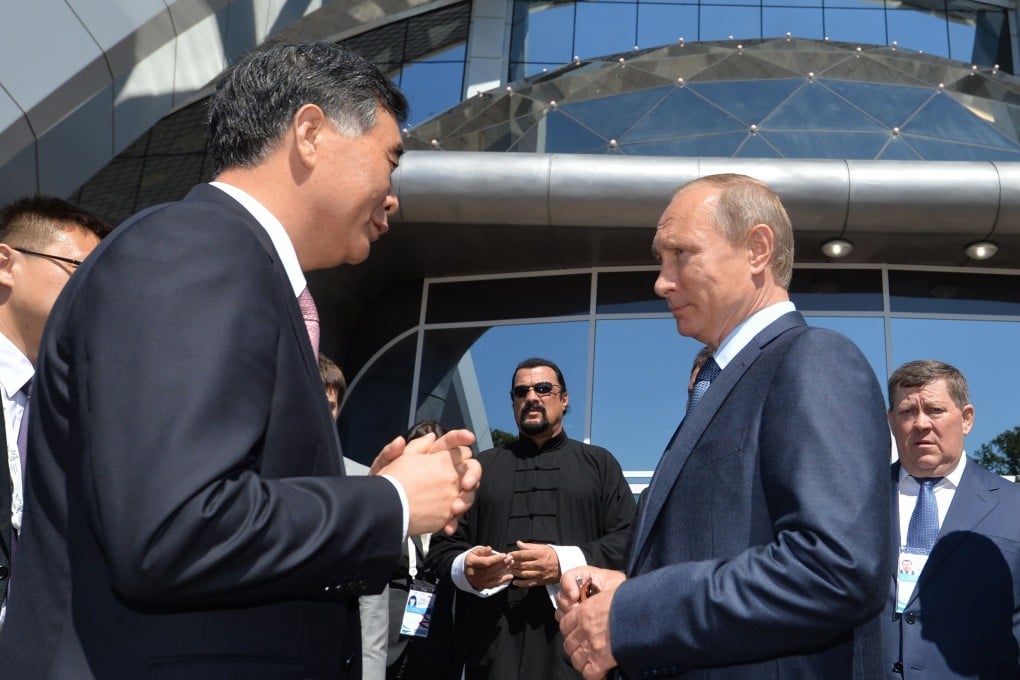 Russian President Vladimir Putin, right, speaks with Chinese Vice Premier Wang Yang as US action movie actor Steven Seagal looks on at Russia's first Eastern Economic Forum in Vladivostok on Friday. Photo: AFP