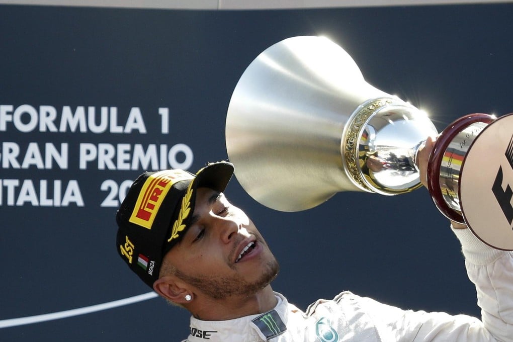 Mercedes F1 driver Lewis Hamilton of Britain celebrates his victory in the Italian F1 Grand Prix in Monza, which provisionally extended his drivers' lead. Photo: Reuters