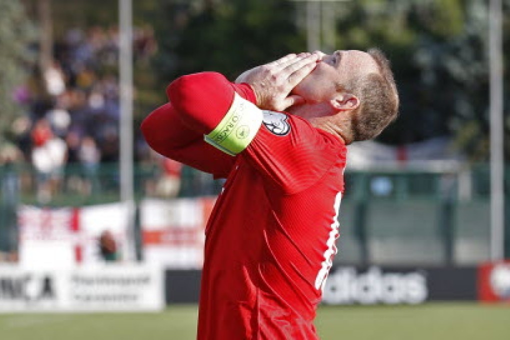 England's Wayne Rooney celebrates after scoring the first goal for his side from the penalty spot to equal Bobby Charlton's goal scoring record. Photos: Reuters