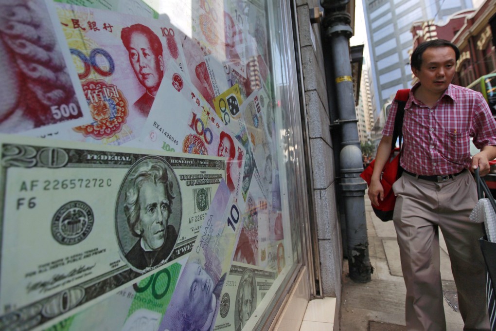 The chinese yuan and the US dollar are seen at a foreign exchange dealer in Hong Kong as Beijing's foreign exchange reserves are seen falling in August in its attempt to prop up the currency. Photo: EPA