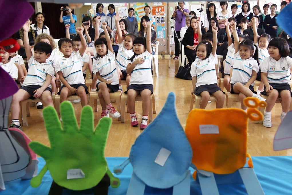 Children learn proper ways of handwashing in a kindergarten. Photo: May Tse