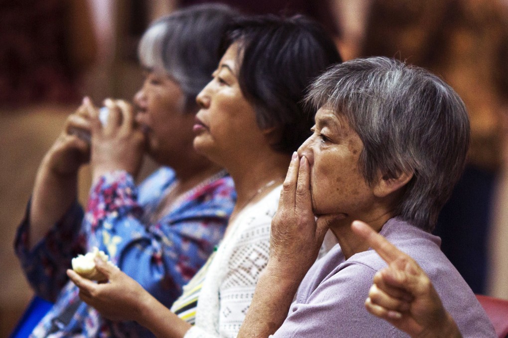 Chinese investors monitor stock prices at a brokerage in Beijing. Photo: AP