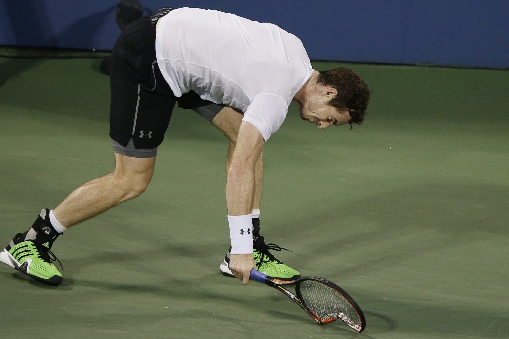 Andy Murray smashes his racquet in frustration after losing a point to Kevin Anderson during their fourth round match. Photo: EPA