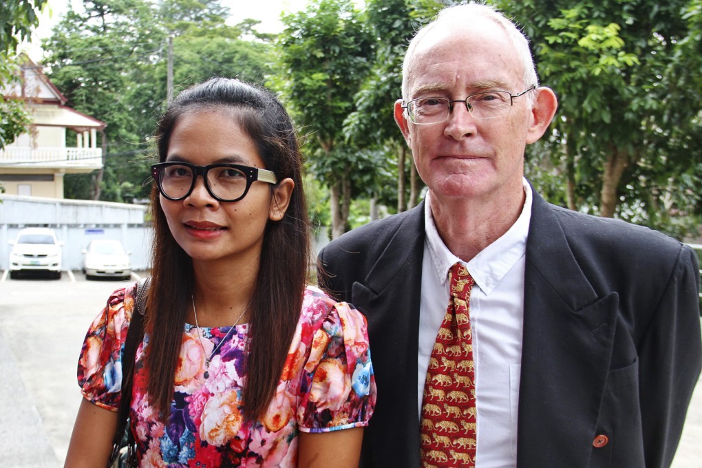 Australian journalist Alan Morison (right) and Thai journalist Chutima Sidasathian smile as they arrive at court in Phuket, Thailand. Photo: EPA
