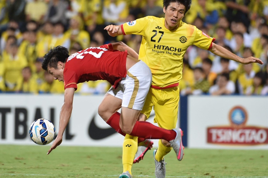 Guangzhou Evergrande midfielder Zheng Long, left, fights for the ball durjng an AFC Champions League quarterfinal match last month. Alibaba founder Jack Ma Yun bought 40 per cent of the team last year after getting drunk with its owner. He now has bigger plans for China's sports industry. Photo: AFP