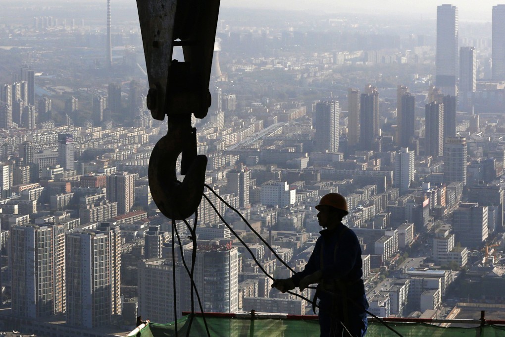 A worker operates at a construction site on the 68th storey of a building in Shenyang, Liaoning. The National Bureau of Statistics will now calculate GDP 'more accurately' based on economic activity each quarter. Photo: Reuters