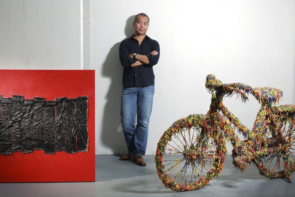 Noel de Guzman with Balancing Rainbow and another of his works. He has been experimenting with new techniques and says, "I felt like I was born again and I can do anything I want."
