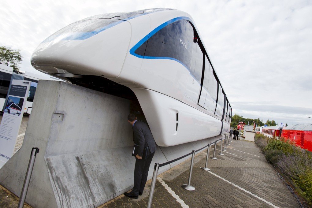 A man looks underneath an Innovia Monorail 300 train by Bombardier Transportation. Photo: Reuters